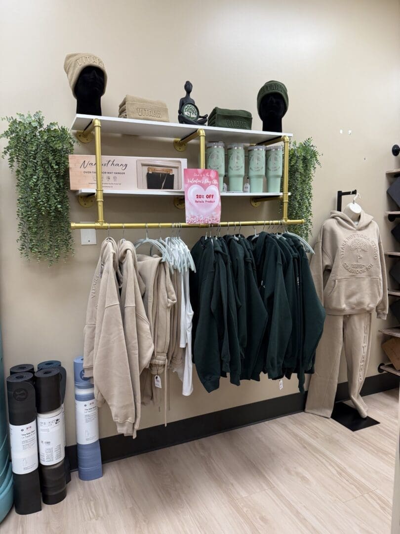 Retail rack of neutral and green hoodies